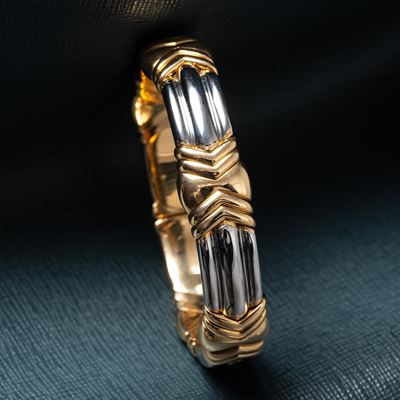 Bracciale “Parentesi” in acciaio e oro giallo 18 kt
