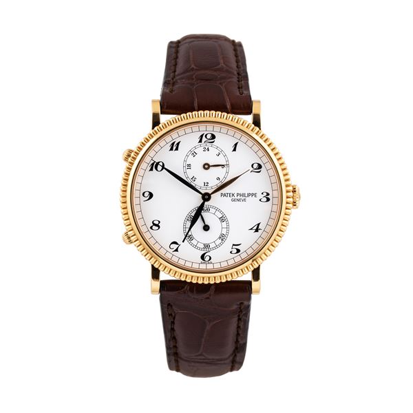PATEK PHILIPPE - PATEK PHILIPPE - TRAVEL TIME OROLOGIO SOLO TEMPO A CARICA MANUALE IN ORO GIALLO 18KT CON DOPPIO FUSO ORARIO, VENTIQUATTRO ORE E GHIERA LAVORATA.
