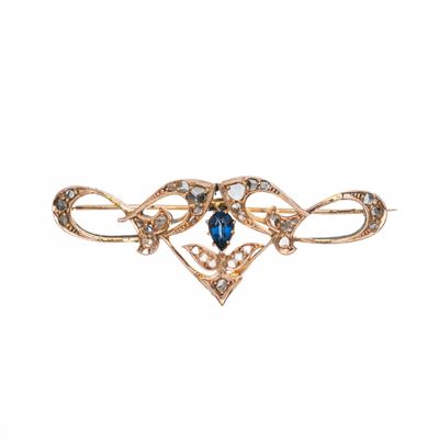 Spilla a fiocco, oro giallo 18 kt con zaffiro a goccia (circa 0,50 ct)