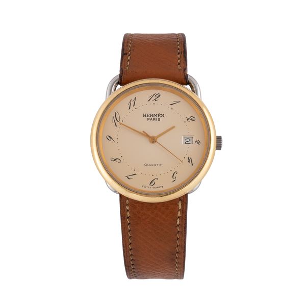 HERMÈS - HERMES OROLOGIO SOLO TEMPO AL QUARZO IN ACCIAIO CON QUADRANTE CHAMPAGNE, GHIERA DORATA E DATARIO AD ORE TRE