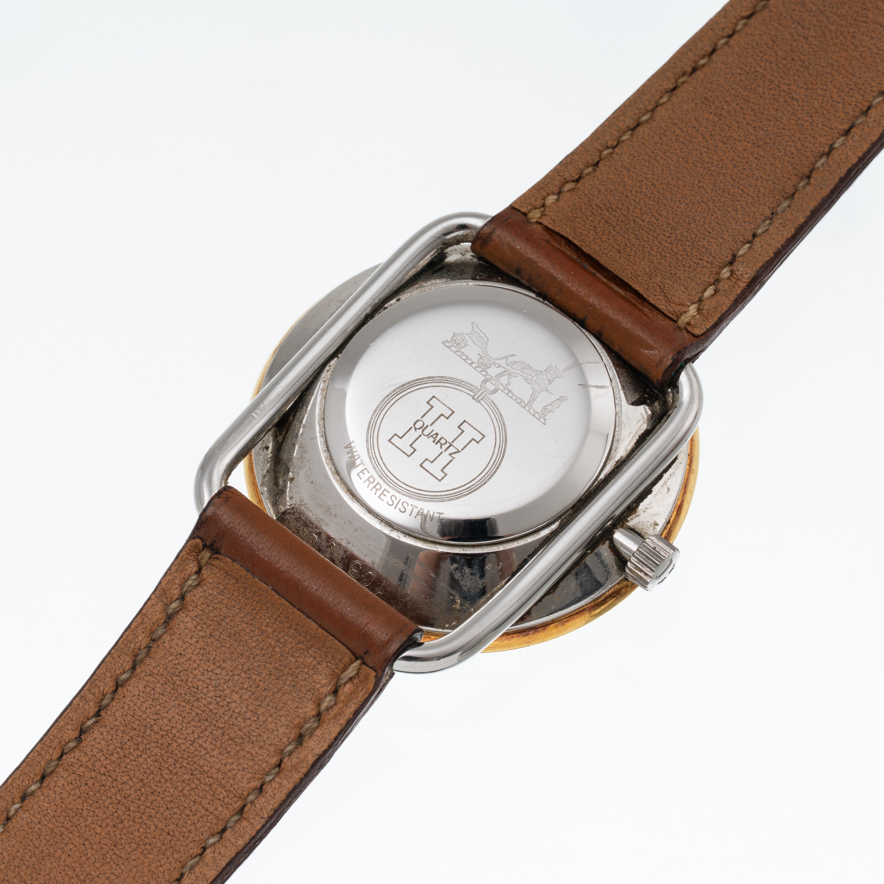 Hermès - Orologio Solo Tempo al quarzo in acciaio con quadrante champagne, ghiera dorata e datari...