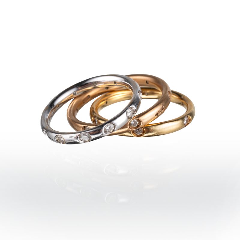 Pomellato - Tre fedine in oro 18 kt con diamanti modello “Lucciole”