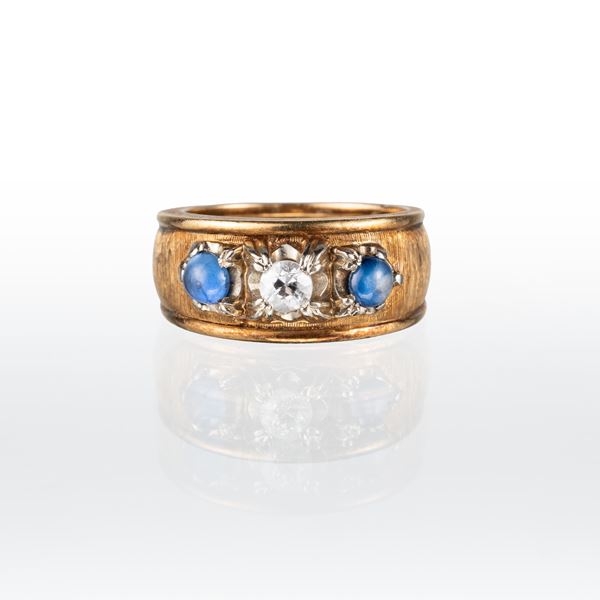 ANELLO IN ORO GIALLO 18 KT, CON DUE ZAFFIRI E DIAMANTE